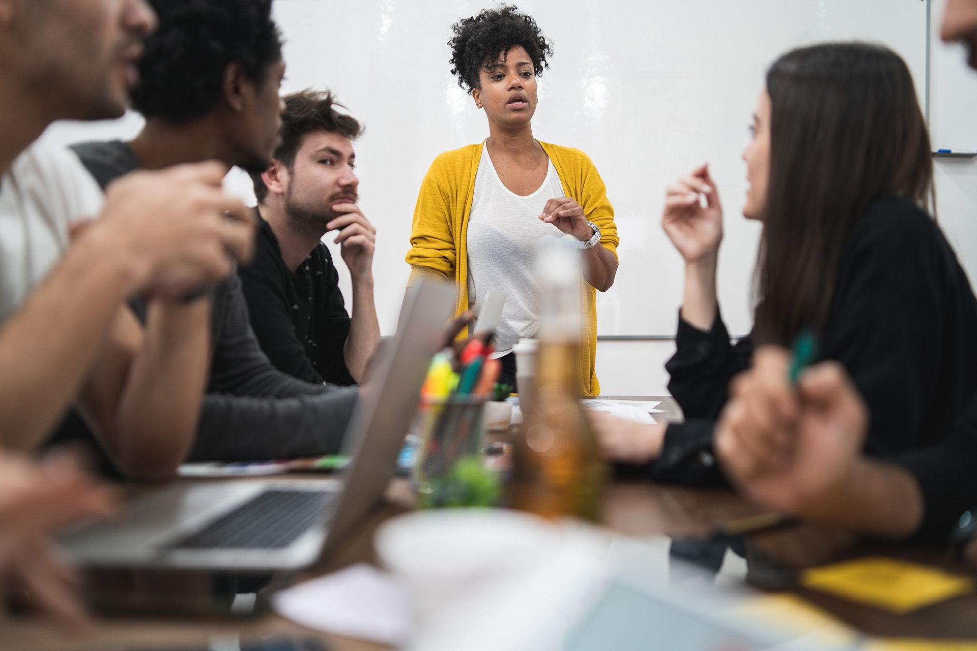 A person leading a brainstorming meeting of several people